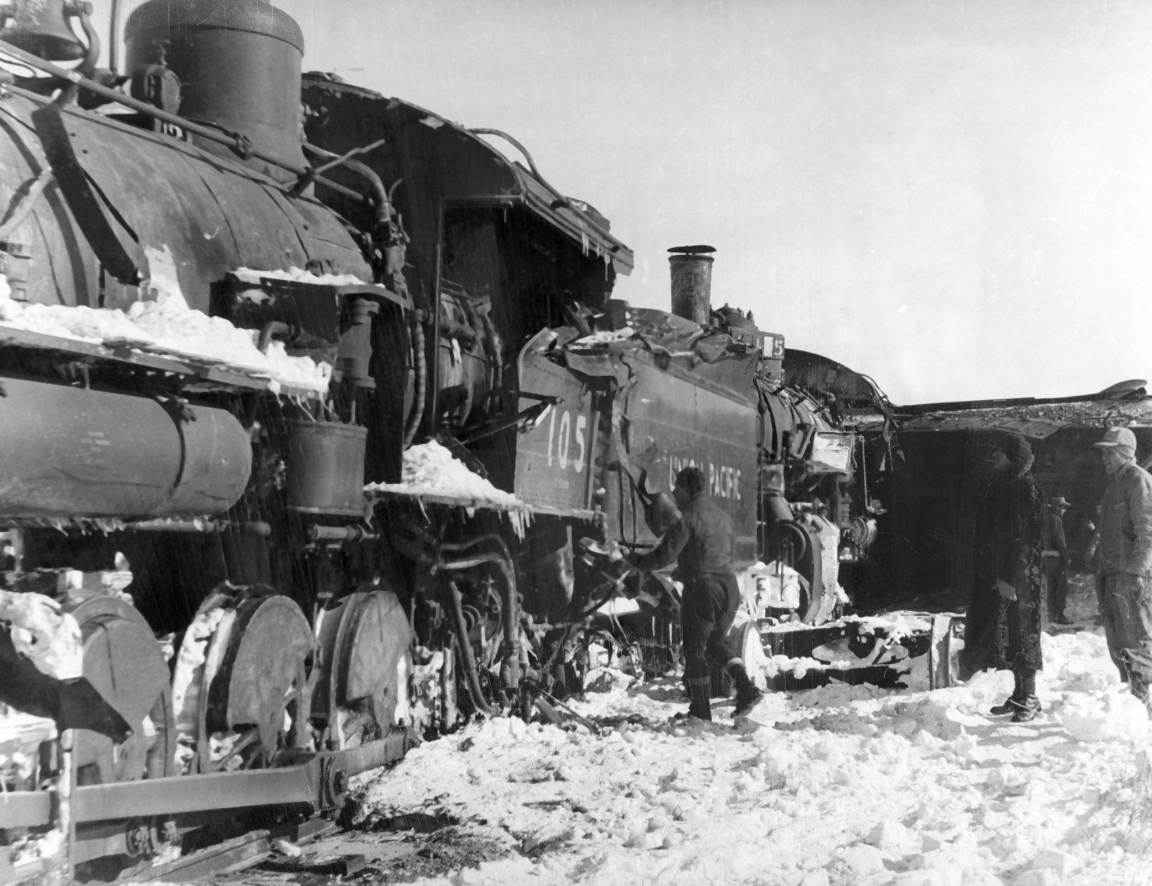 One trainman was killed and another injured in the snowplow wreck seven miles east of Stapleton, Nebraska. The two engines were pushing the wedge plow when it struck a hard packed drift. The blade swung around, ripped along the first engine and plunged into the second engine, killing brakeman E.L. Rodman of Kearney. Published Jan. 20, 1949.